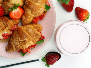 Delicious croissants, a glass of yogurt. Flat lay