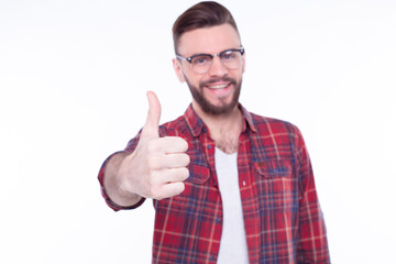 Attractive cheerful young man wearing checkered shirt standing isolated over white background and...