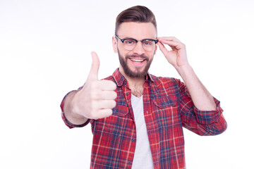 Attractive cheerful young man wearing checkered shirt standing isolated over white background and...