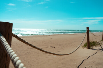Obraz premium ROPE ON BEACH AT THE OCEAN