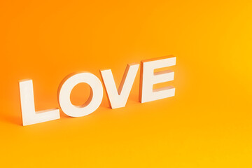 Word LOVE on orange background.