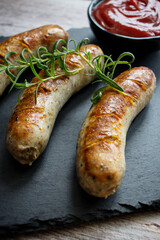 
Fried homemade sausages on a wooden background. With sauces. lunch