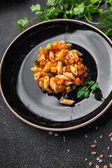 pasta salad tomato, cucumber, corn, fresh vegetable, penne pasta meal food snack on the table copy space food background rustic top view 