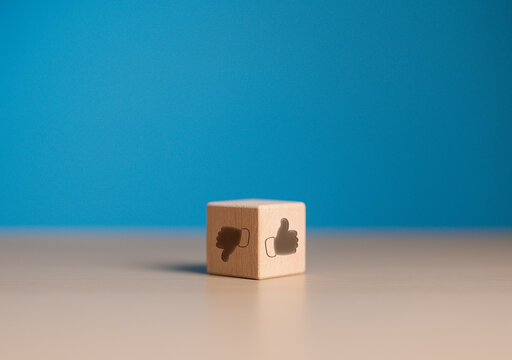 Approval or refusal. Thumb up and down icon on wooden cube face. Accepted or Rejected concept. Like and Dislike icons on opposite side of wooden block. Client service rating, satisfaction concept
