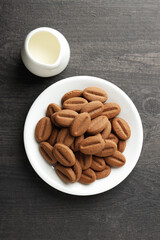 Concept of tasty snack for hot drink - cookies in the shape of coffee seeds