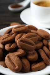 Concept of tasty snack for hot drink - cookies in the shape of coffee seeds