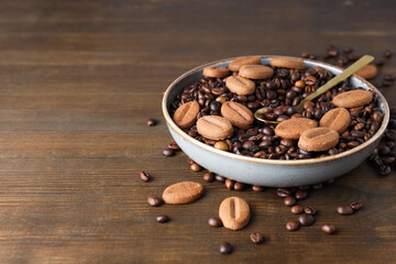 Concept of tasty snack for hot drink - cookies in the shape of coffee seeds