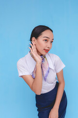 A flight attendant listening to someone. A stewardess asking a passenger to raise their voice. Telling someone they can't hear.