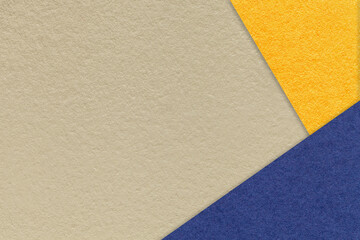 Fototapeta na wymiar Texture of craft beige color paper background with yellow and navy blue border. Vintage abstract cardboard.