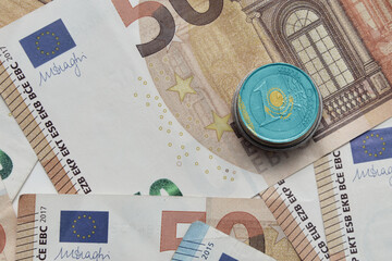 euro coin with national colorful flag of kazakhstan on the euro money banknotes background