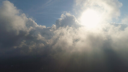 aerial view sky with clouds and sun rays. cloudscape view over white fluffy clouds. aerial landscape