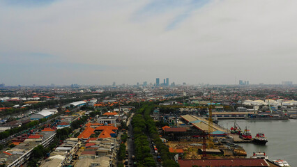 Aerial cityscape densely built asian city, seaport. urban environment in asia. modern city Surabaya with buildings and houses. Surabaya capital city east java, indonesia