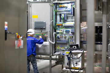 Electrician engineer tests electrical box control