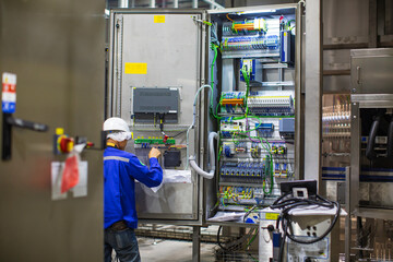 Electrician engineer tests electrical box control