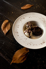 Brownie with ice cream in a white deep plate