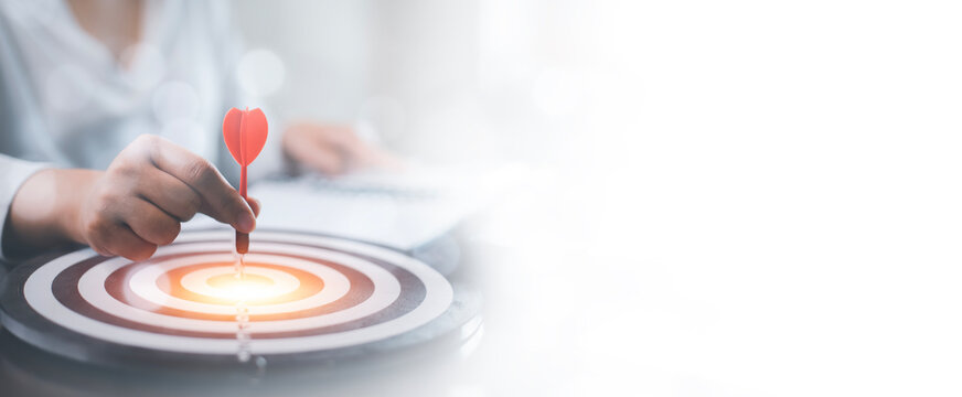 New Targeting with marketing business concept, Businessman hand holding red dart to the virtual target dartboard, Executive marketing, investment goal and target for business investment concept,