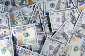 Fototapeta premium One hundred dollars banknotes background. dollars banknotes. 100 American dollars. Benjamin Franklin. paper money, currency, cash. finance, payments. close-up. Free space for your text.