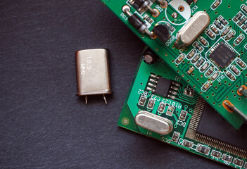 A crystal oscillator (16 Mhz).  Frequency-determining element in digital electronic circuit boards.