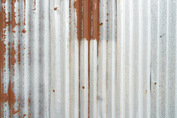 The Rusty zinc sheet texture and background, Reddish brown stain on metallic silver