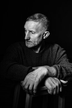 portrait of a sad elderly man with a beard, black and white dark photo