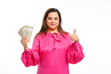 Young indian woman showing five hundred bank note on white background.