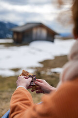 Eating chocolate and bread snack during hike in mountains