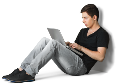 Portrait of a Young Man Using a Laptop While Sitting on the Floor