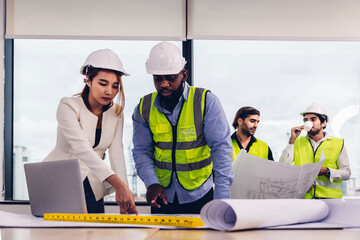 Team Engineers with draft plan of building on constructing site. Engineer work on site. engineer visit and inspection site engineer. Inspector engineer check and working on site.