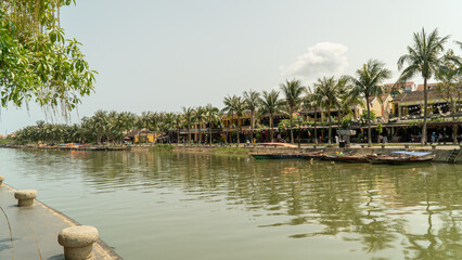 Embankment of the river in the city with palm trees