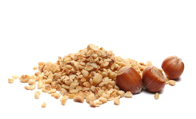 Pile chopped and roasted hazelnut isolated on white, side view