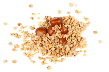 Pile chopped and roasted hazelnut isolated on white, top view