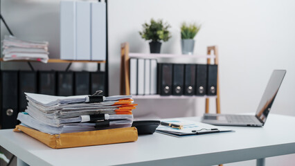 Naklejka premium Stylish workspace with laptop, notebook, blank screen laptop on white table of bookkeeping.