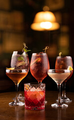 collection of refreshing cocktail glass in lillet spritz aperol party with lime red berries and negroni mint and ice with blur pub background in chilled glass