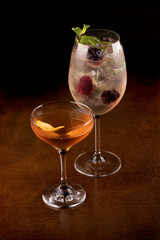 Two cocktail glasses on wooden table with top background