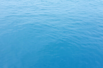 Blue Sea surface aerial view with waves from a drone, empty blank to background. soft focus.