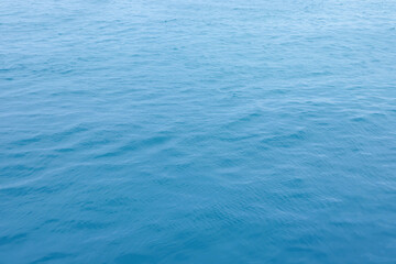 Blue Sea surface aerial view with waves from a drone, empty blank to background. soft focus.