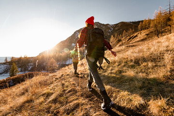 Two hikers walks with backpacks in mountains. Hiking concept