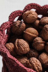 Fresh organic whole walnuts in a crochet bag. Storage bag with nuts.