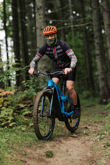 Fototapeta premium Mountain biker riding on bike in autumn inspirational mountains landscape banner. Man cycling MTB on enduro trail track. Sport fitness motivation and inspiration.