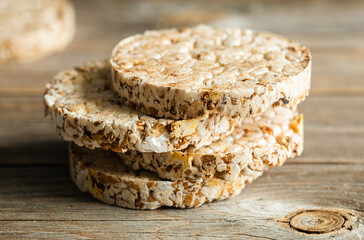 Close-up, rice cakes on wooden background. Tasty crisps, snack with health benefits.