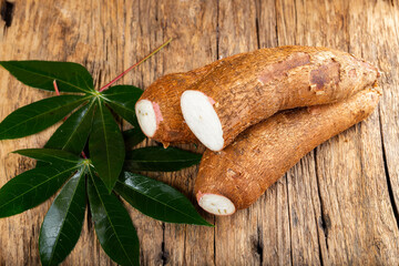 cassava pile, yucca, on a background of rustic wood (Manihot esculenta)