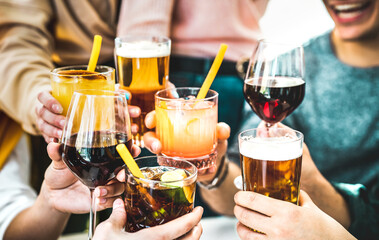 Friends hands toasting fancy cocktails - Young people having fun together drinking beer and wine at...