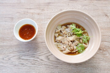 stewed duck intestine in brown soy soup on bowl dipping spicy sauce