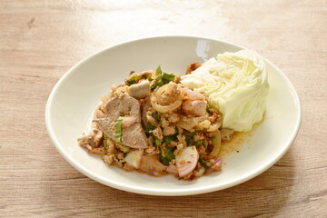 Thai spicy chop pork and slice skin salad with fresh vegetable on plate