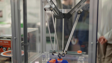 Industrial robotic arm on long tubes moving product around