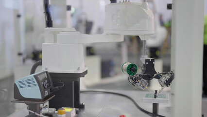 Industrial robot inside the closed window box working on a product