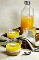 Homemade layered vegan dessert of baked coconut cream and chocolate in basket with milk bottle