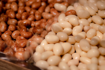Oval glazed candy nuts on the counter in the store.