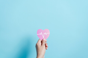 Hand holding red heart donation with pulse cardiogram, health care, organ donation, family life...