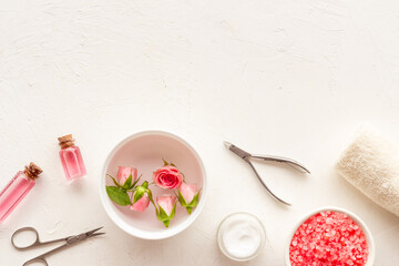Pink roses flowers and manicure tools. Beauty nail care spa salon.